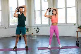 man and woman working out with kettlebells